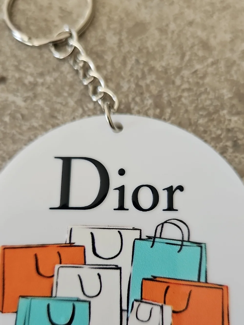 Fashion White Round Key chain with Orange, Teal and Cream Shopping Bags - Picture 3 of 3
